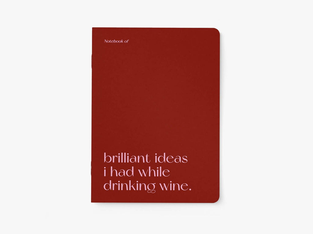 Red notebook with text 'Notebook of brilliant ideas I had while drinking wine' on a white background