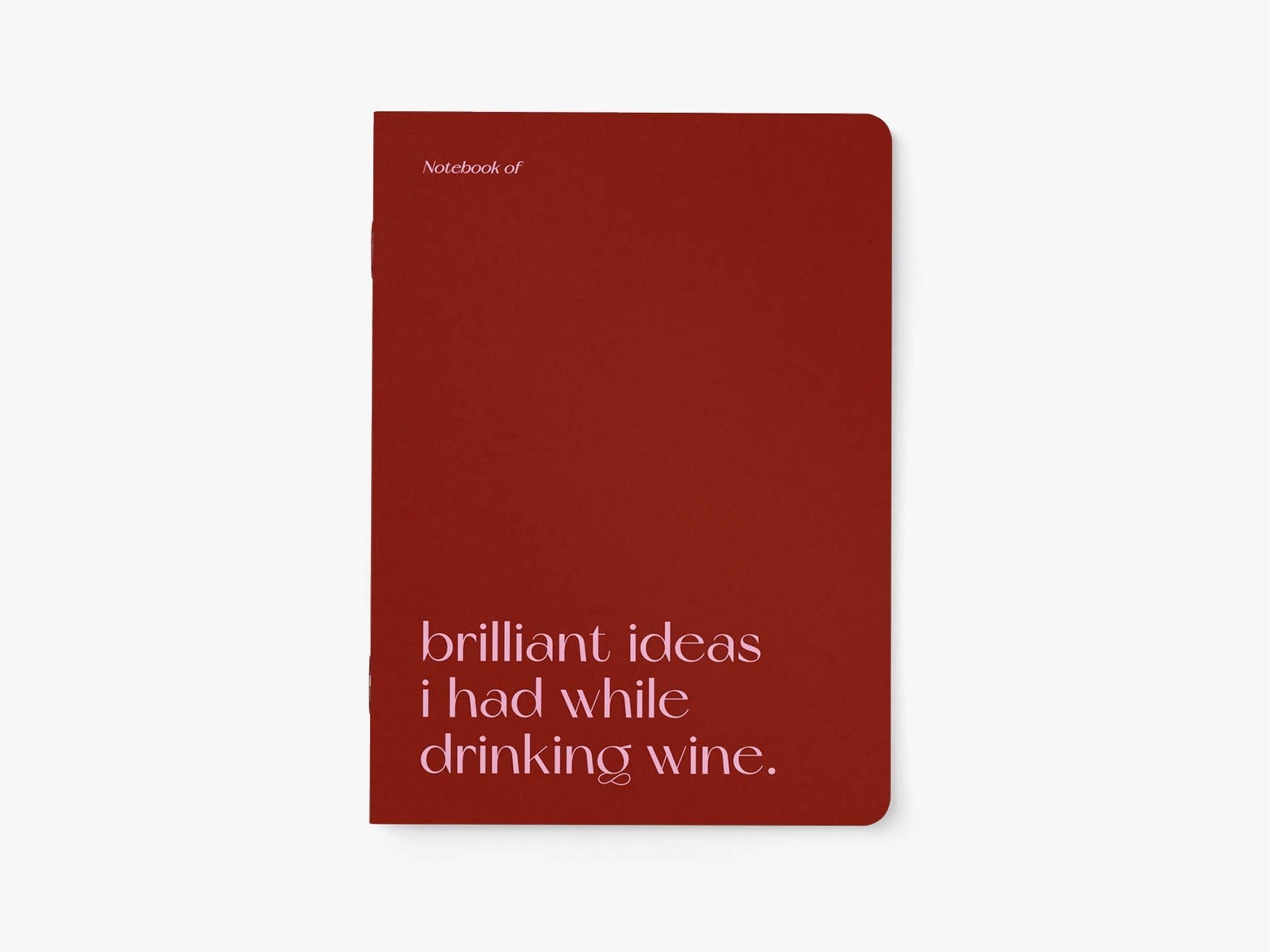 Red notebook with text 'Notebook of brilliant ideas I had while drinking wine' on a white background